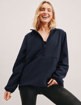 blue fleece quarter zip jacket with a kangaroo pocket.